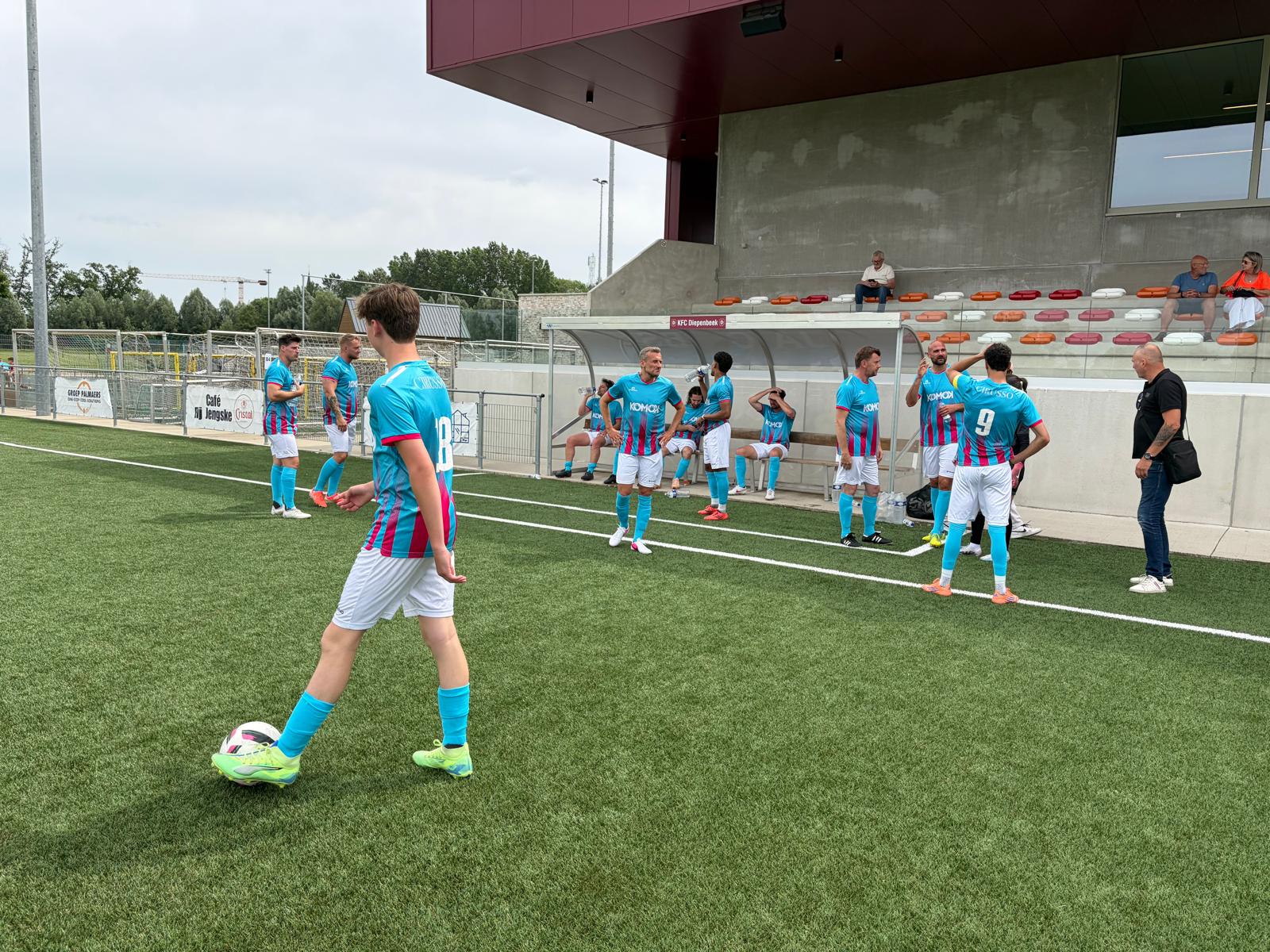 Voetbalwedstrijd KOMOK – spelers aan de kant, juni 2026